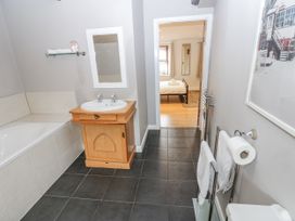A bathroom with a sink and bathtub at Mill Race House in Alston