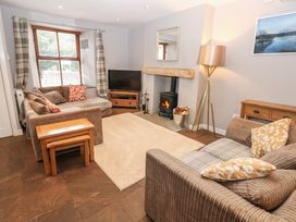 A living room with sofas and a television at Mill Race House Alston
