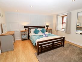 A bedroom with a bed and a dresser at Mill Race House Alston