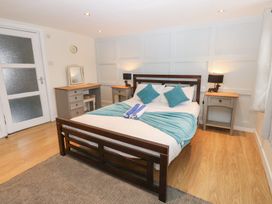 A bedroom with a bed and bedside tables at Mill Race House Alston