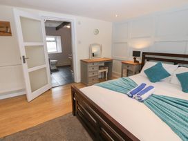 A bedroom with a bed and desk at Mill Race House in Alston