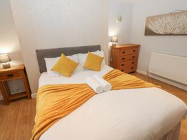 A bedroom with a bed and bedside table at Mill Race House Alston