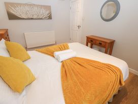 A bedroom with a bed and nightstand at Mill Race House in Alston