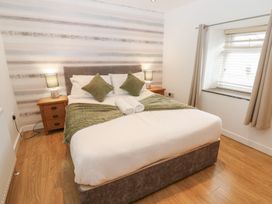 A bedroom with a bed and bedside table at Mill Race House Alston