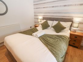A bedroom with a bed and nightstand at Mill Race House Alston