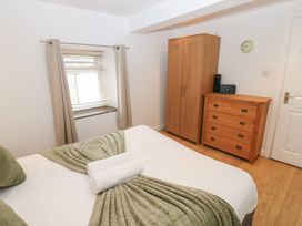 A bedroom with a bed and furniture at Mill Race House in Alston