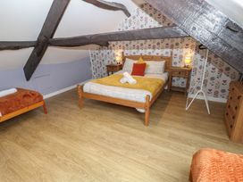 A bedroom with a bed and bedside tables at Mill Race House Alston