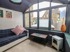 A snug with a sofa and coffee table at Mill Race House in Alston