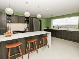 A kitchen with modern fixtures and a large window at Twyn Isaf in Borth