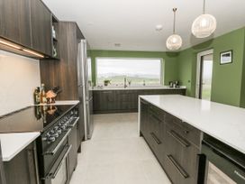 A kitchen with appliances and cabinetry at Twyn Isaf in Borth
