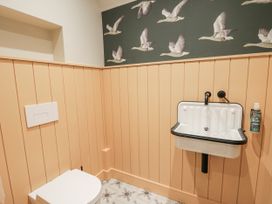 A bathroom with a toilet and a sink at Twyn Isaf Borth
