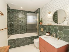 A bathroom with a bathtub a sink and a toilet at Twyn Isaf in Borth