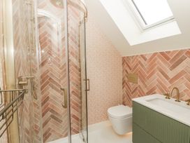 A bathroom with shower, toilet, and sink at Twyn Isaf in Borth
