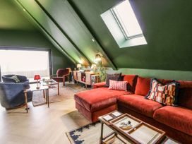 A living room with a sofa and coffee table at Twyn Isaf in Borth