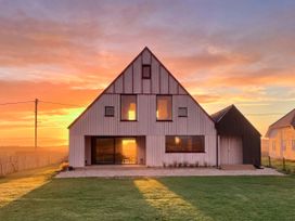 A house with large windows and a door at Twyn Isaf in Borth