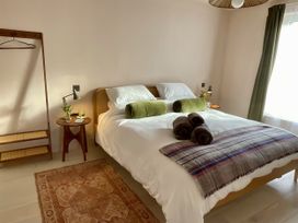 A bedroom with a bed and side table at Twyn Isaf in Borth