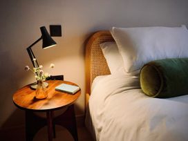 A bedroom with a bed and nightstand at Twyn Isaf in Borth