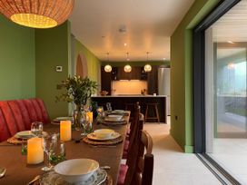 A dining room with a table set for a meal at Twyn Isaf in Borth