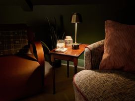 A living room with a table and lamp at Twyn Isaf Borth