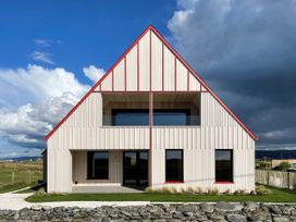 A house with a sloped roof and large windows at Twyn Isaf Borth