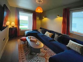 A living room with a sofa and coffee table at Twyn Isaf in Borth