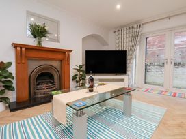 A living room with a television and a coffee table at 32 Quay Street Scarborough