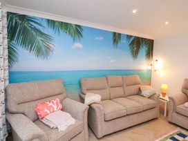 A living room with a wall mural and two sofas at 32 Quay Street in Scarborough
