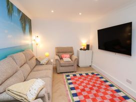 A living room with a sofa and television at 32 Quay Street in Scarborough