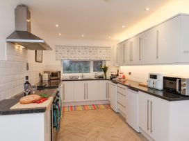 A kitchen with a cooking range and microwave at 32 Quay Street Scarborough