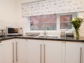 A kitchen with a sink and microwave at 32 Quay Street, Scarborough