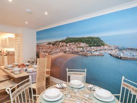 A dining room with a wall mural and a table set at 32 Quay Street in Scarborough
