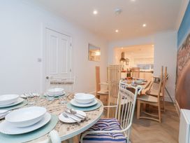 A dining room with a table set for meals at 32 Quay Street in Scarborough