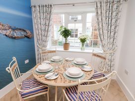 A dining room with a table set for meals at 32 Quay Street Scarborough