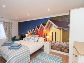 A bedroom with a bed and wall mural at 32 Quay Street in Scarborough