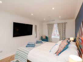 A bedroom with a bed and television at 32 Quay Street Scarborough