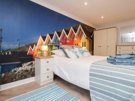 A bedroom with a bed and a wall mural at 32 Quay Street in Scarborough
