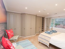 A bedroom with a bed and wardrobe at 32 Quay Street Scarborough