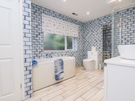 A bathroom with a bathtub, toilet, sink, and shower at 32 Quay Street Scarborough