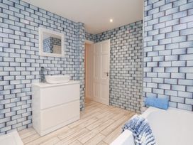 A bathroom with sink and bathtub at 32 Quay Street Scarborough