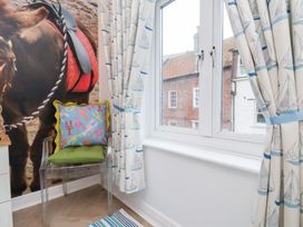A bedroom with a chair and window at 32 Quay Street Scarborough