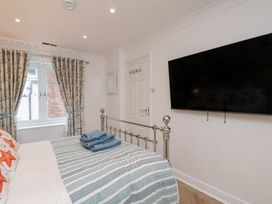 A bedroom with a bed and television at 32 Quay Street Scarborough