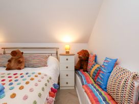 A bedroom with a bed and colorful cushions at 32 Quay Street in Scarborough