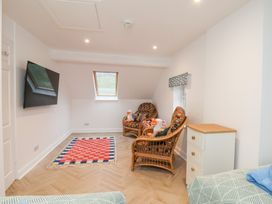 A living room with rattan chairs and a television at 32 Quay Street Scarborough