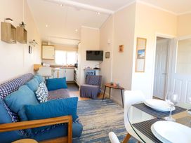 A living room with a sofa and television at Boa Vista in Bacton
