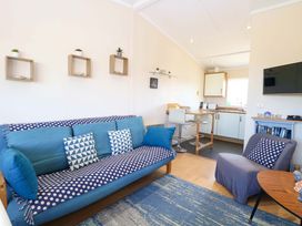 A living room with a sofa and armchair at Boa Vista in Bacton