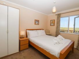A bedroom with a bed and wardrobe at Boa Vista Bacton