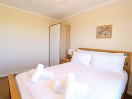 A bedroom with a bed and towels on top at Boa Vista in Bacton