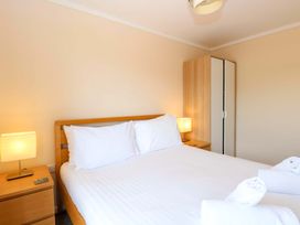 A bedroom with a bed and a wardrobe at Boa Vista in Bacton