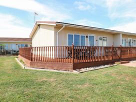 An outdoor view of a property with a wooden deck at Boa Vista in Bacton