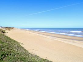 A beach with sand and ocean at Boa Vista in Bacton